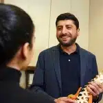 Dr. Neel Kumar explains chiropractic treatment plan to patient during initial evaluation examination